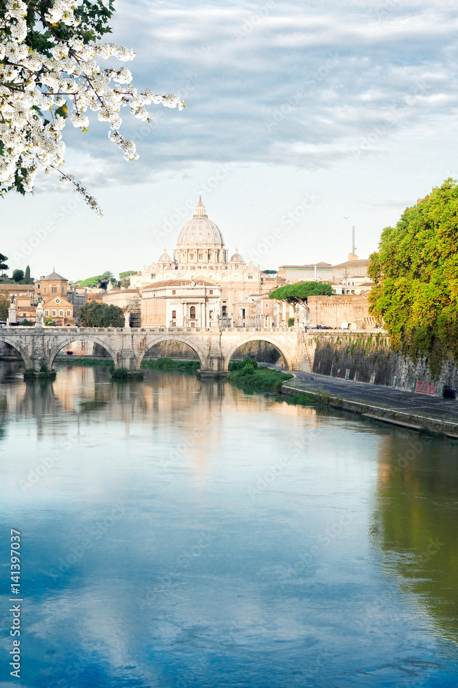 St. Peter's cathedral over bridge and river Tiber water in Rome at spring day, Italy