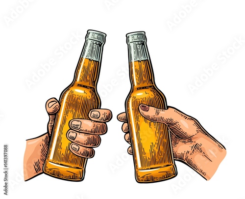 Female and male hands holding and clinking open beer bottles.