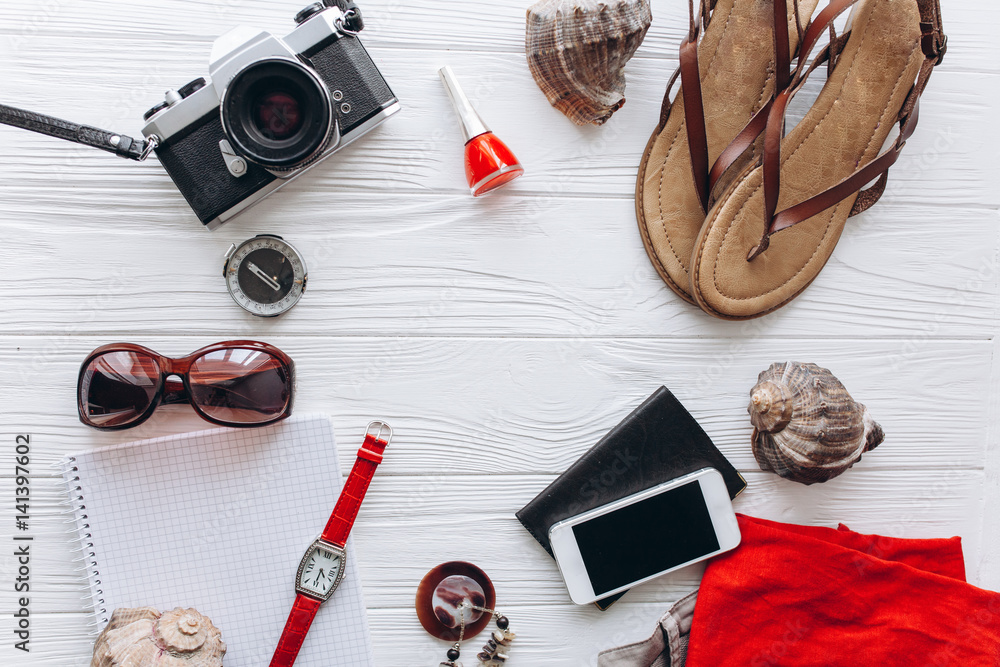 Top view of female travel accessories set on blue wooden background with copy space Top view of female travel accessories set on blue wooden background with copy space