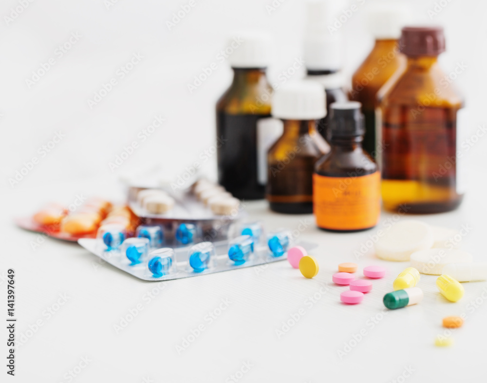 Composition of medicine bottles and pills on white background Composition of medicine bottles and pills on white background