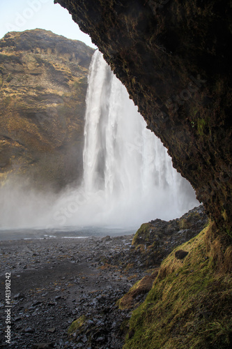 Skógafoss waterfall in southern Iceland on a cloudy winter day. It is located on the river Skógá and is one of the largest waterfalls in the country. 