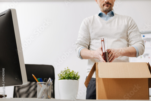 Involved staff member packing the box and leaving the office