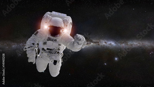 Fototapeta Naklejka Na Ścianę i Meble -  astronaut in front of the Milky Way galaxy (elements of this image are furnished by NASA)