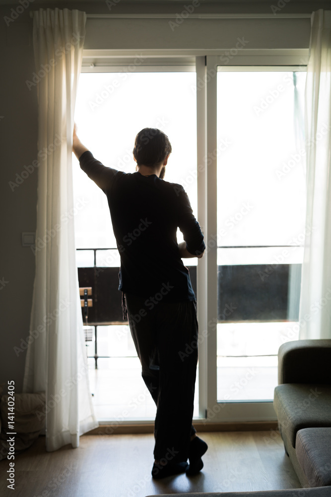 Handsome man standing near window Handsome man standing near window