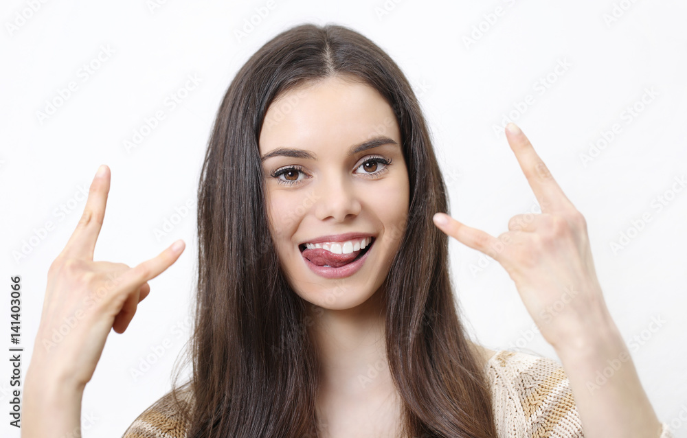 happy woman doing a rock and roll symbol isolated in white background happy woman doing a rock and roll symbol isolated in white background
