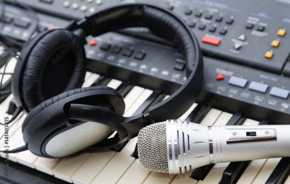 microphone and ear-phones lie on the keyboard microphone and ear-phones lie on the keyboard