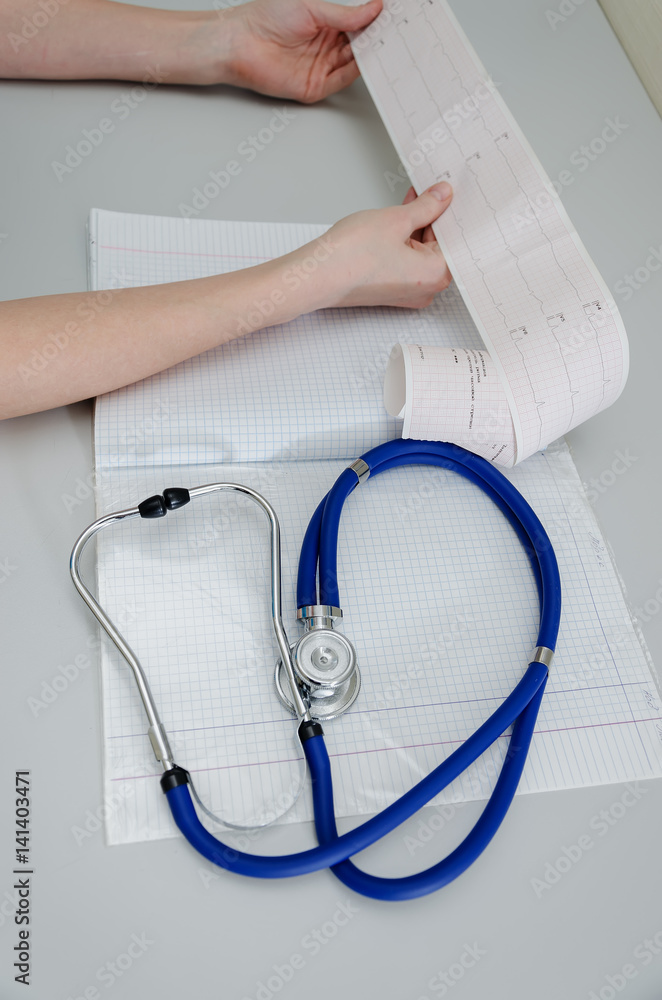 The doctor holds an encephalogram of a healthy patient The doctor holds an encephalogram of a healthy patient