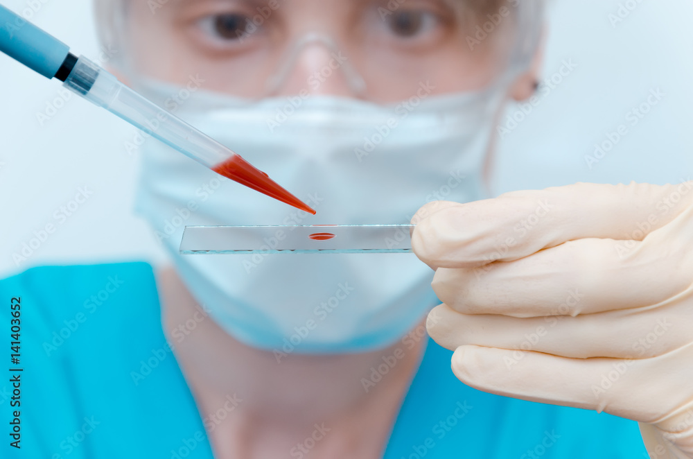 laboratory assistant analyzing a blood sample laboratory assistant analyzing a blood sample