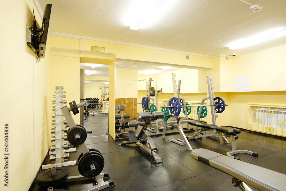 Fototapeta premium Fitness hall with weights and other sport equipment