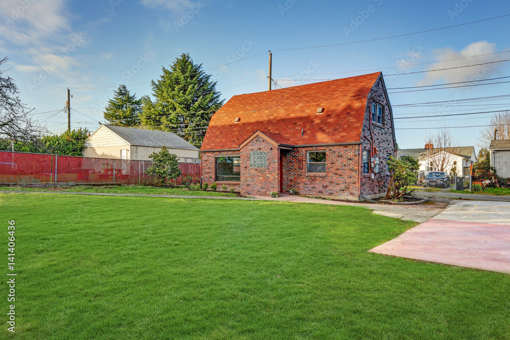 Small red brick home on a sunny day Small red brick home on a sunny day