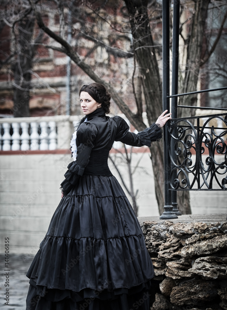 Outdoors portrait of a victorian lady in black