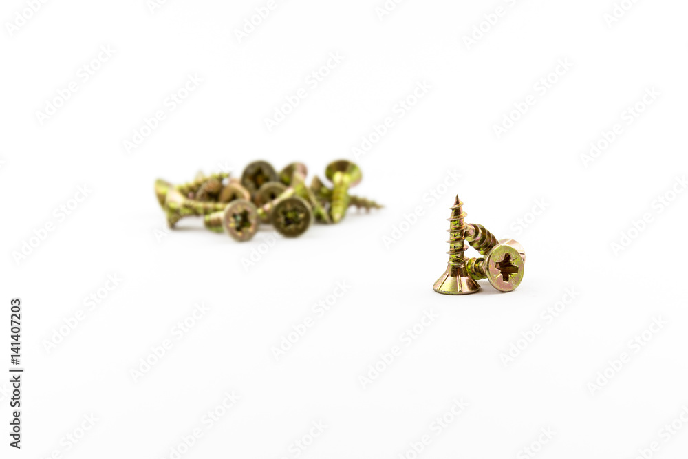 Closeup yellow zinc coated screw isolate on white background. Self Drilling screws. Isolated fasteners. Connecting material on white background. Silver and gold threads on bolts. Closeup yellow zinc coated screw isolate on white background. Self Drilling screws. Isolated fasteners. Connecting material on white background. Silver and gold threads on bolts.