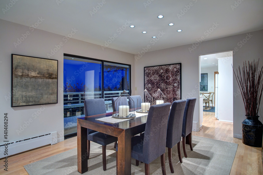 Grey tones dining space with glass doors to large upper deck Grey tones dining space with glass doors to large upper deck