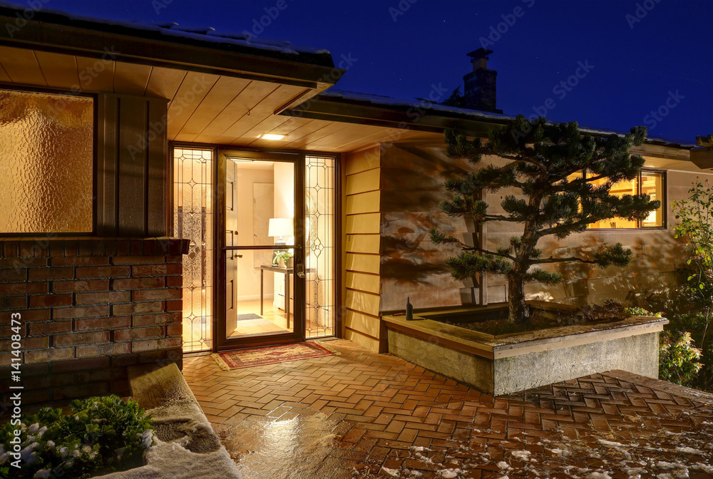 Fototapeta premium Sunset view of front porch with paved walkway
