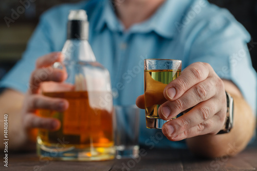 man offering some shot of alcohol as a solution to your problems