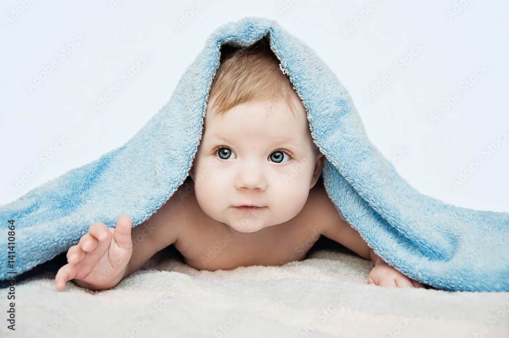 Newborn child relaxing in bed after bath or shower. Nursery for Newborn child relaxing in bed after bath or shower. Nursery for