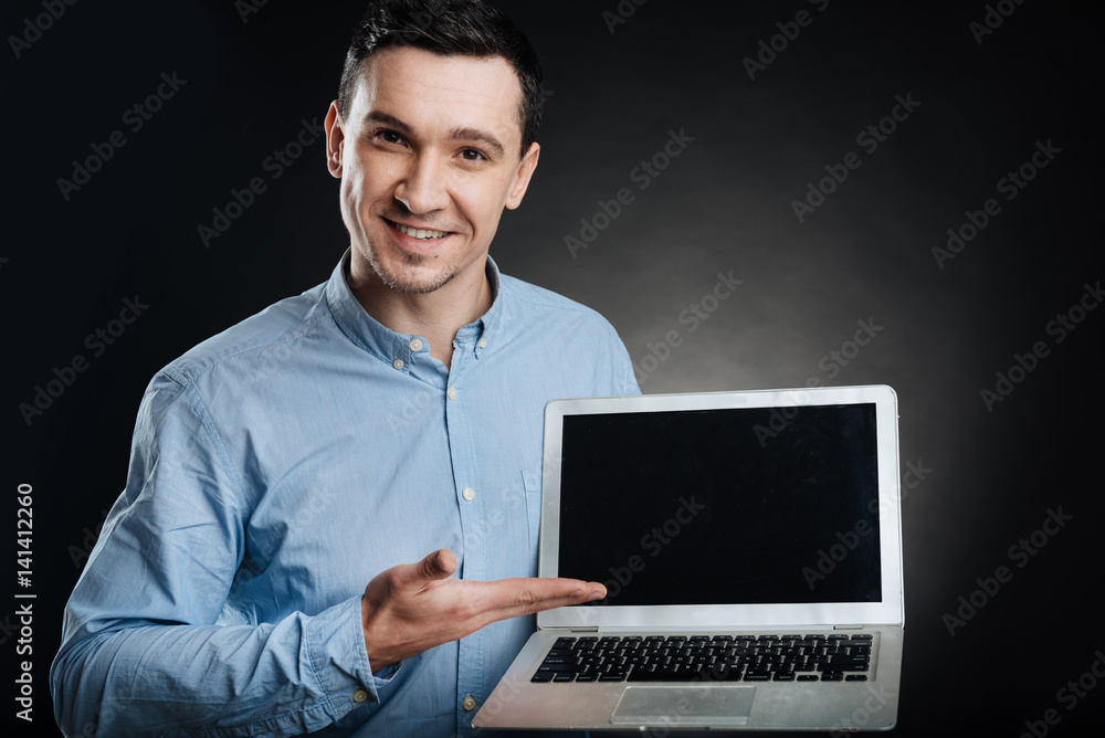 Attractive male presenting his laptop Attractive male presenting his laptop