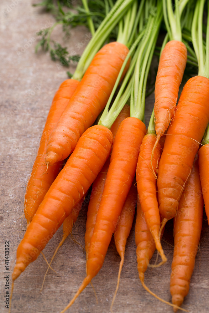 Fresh and sweet carrot on a grey wooden table. Fresh and sweet carrot on a grey wooden table.