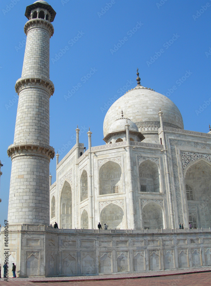 Dramatic Perspective of a minaret tower from the platform of the Taj Mahal mausoleum complex in Agra, India