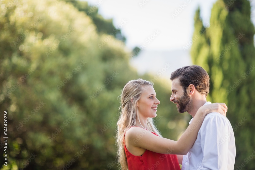 Couple smiling while looking at each other Couple smiling while looking at each other