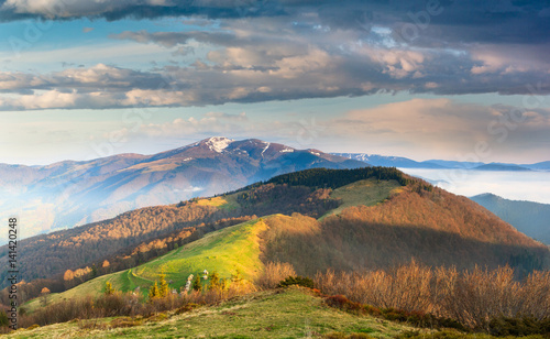 Panoramic landscape in the mountains at sunrise. Dramatic sky with colorful clouds. © vovik_mar