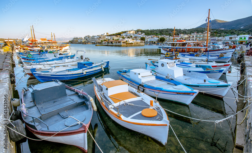The small traditional harbor of Elounda at sunset, Crete, Greece.