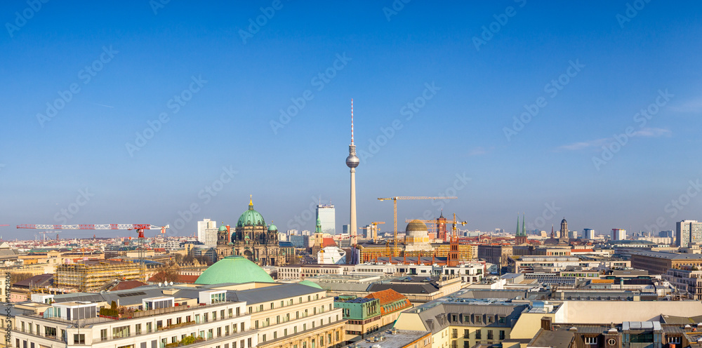 Berlin - Januar 2017: Beautiful panoramic aerial view over Berlin (Berlin Cathedral - Berliner Dom, construction site City Palace - Stadtschloss), with romantic colorful sunset.