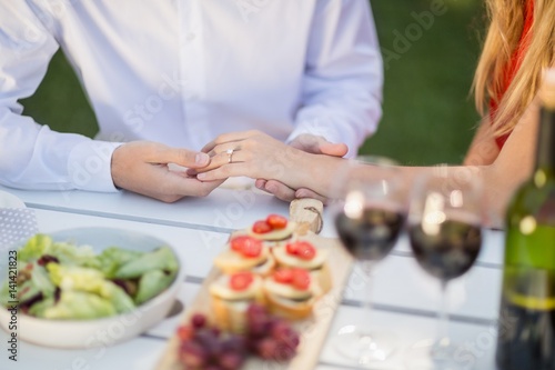 Man holding womans hand in the restaurant