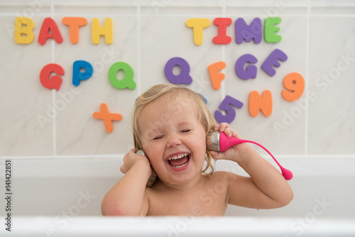 Smily little girl having fun in bath.