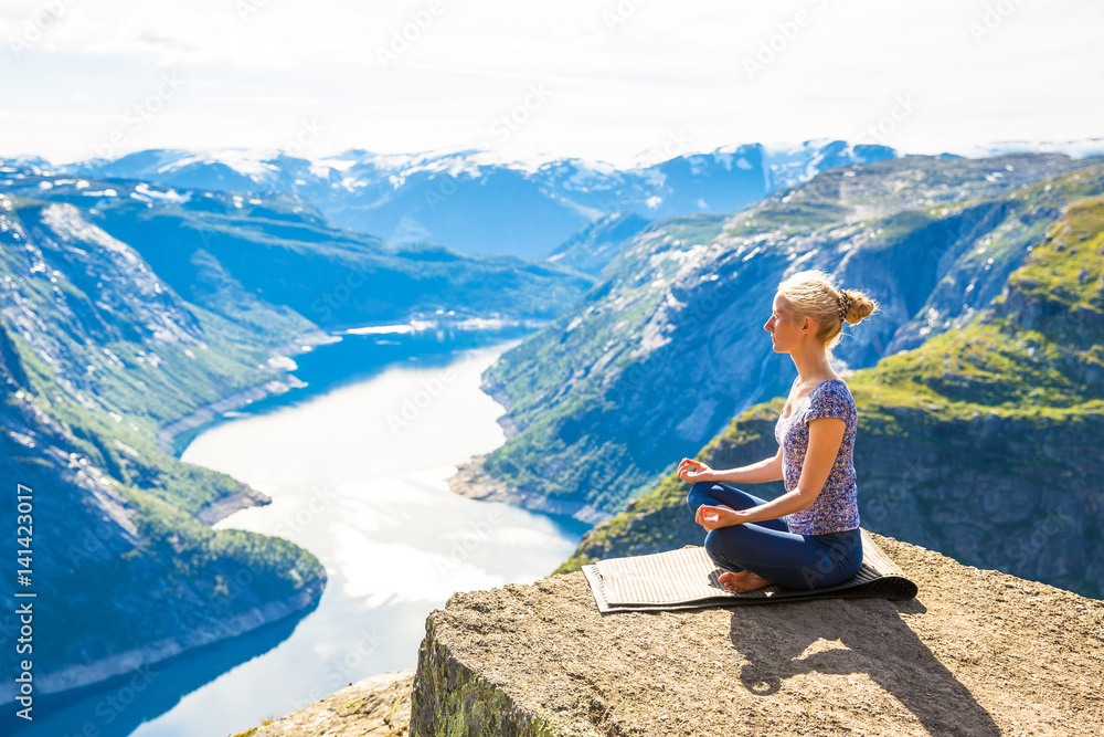 Happy people relax in cliff during trip Norway. Trolltunga hiking route