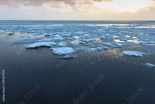 Beautiful winter landscape with ice on water surface