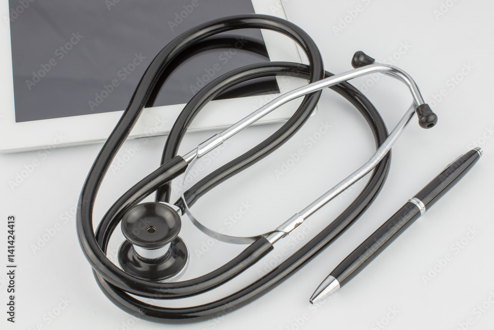 Tablet computer, pen and stethoscope on a white background Tablet computer, pen and stethoscope on a white background