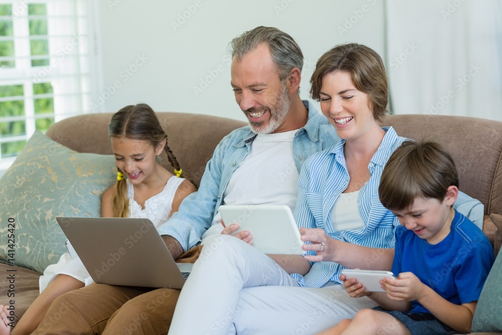 Happy family using mobile phone, digital tablet Happy family using mobile phone, digital tablet