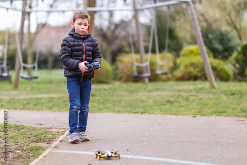 School boy with quadrocopter inthe park photo