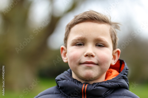 Portrait of school boy in spring park photo