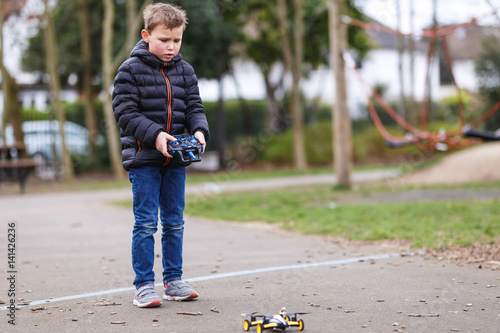 School boy with quadrocopter inthe park photo