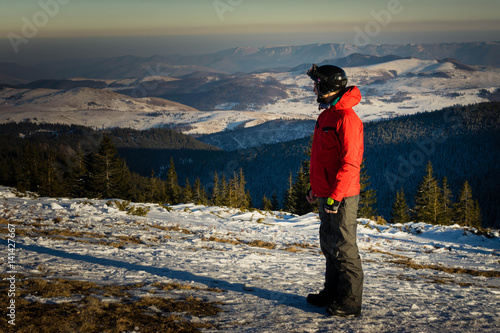 Man on top of the mountain enjoying the winter wiew photo