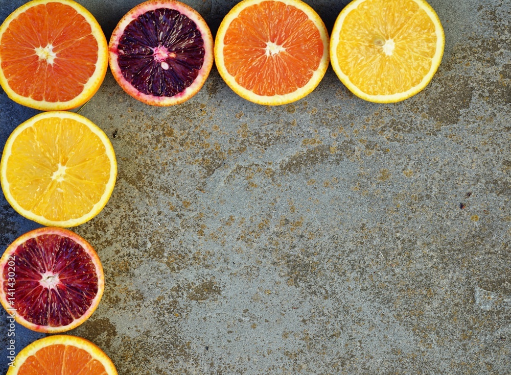 Oranges, blood oranges, and cara cara oranges cut in half forming a