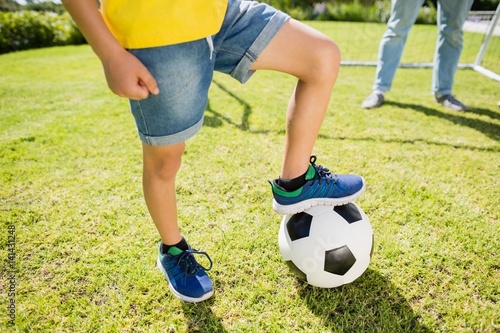 Low section of boy with leg on football © WavebreakMediaMicro