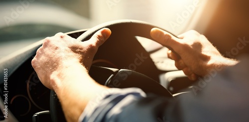 Tablou canvas Cropped hands of man holding steering wheel