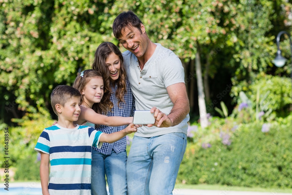 Happy family taking a selfie on mobile phone