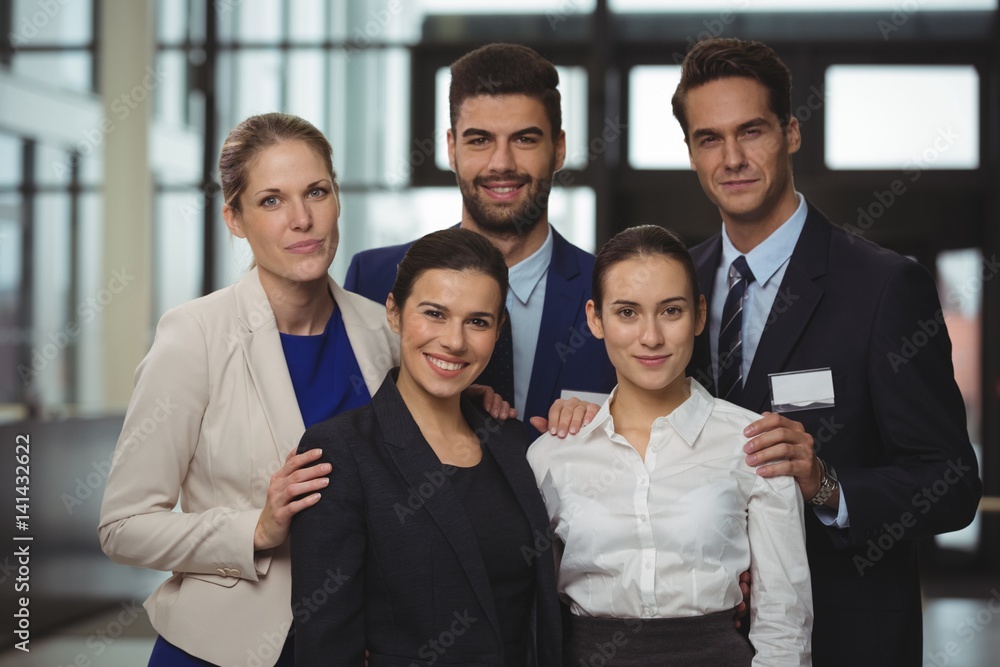 Successful businesspeople standing together in office Successful businesspeople standing together in office