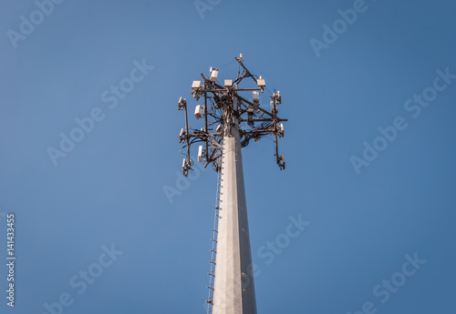 Isolated cellular radio antenna. Radio antenna with clear sky background. Industrial energy power design. Minimal design and detail. Broadcast tower. Steel beam tower. 