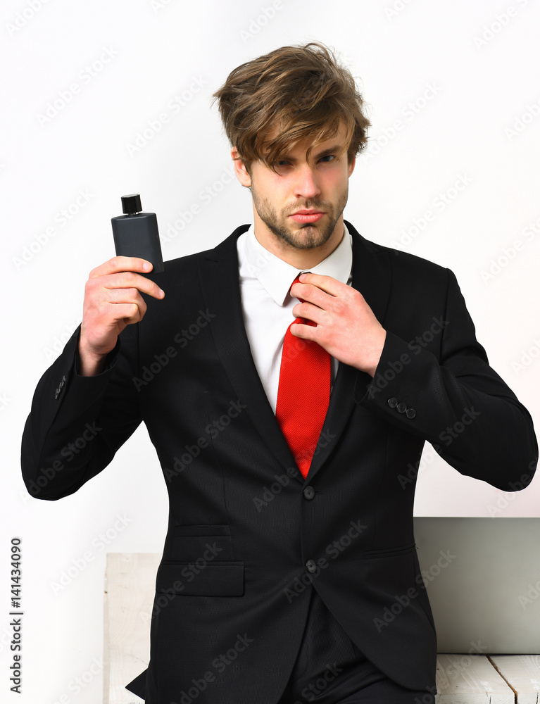 Caucasian stylish business man posing with perfume Caucasian stylish business man posing with perfume
