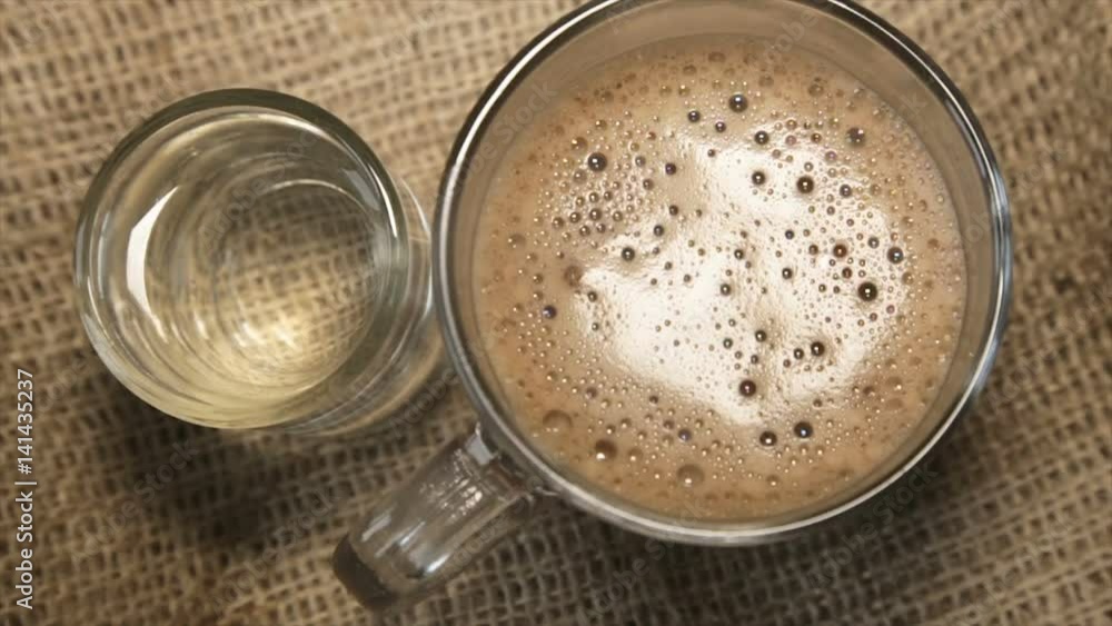 Glass cup of cappuccino and a glass of water Glass cup of cappuccino and a glass of water