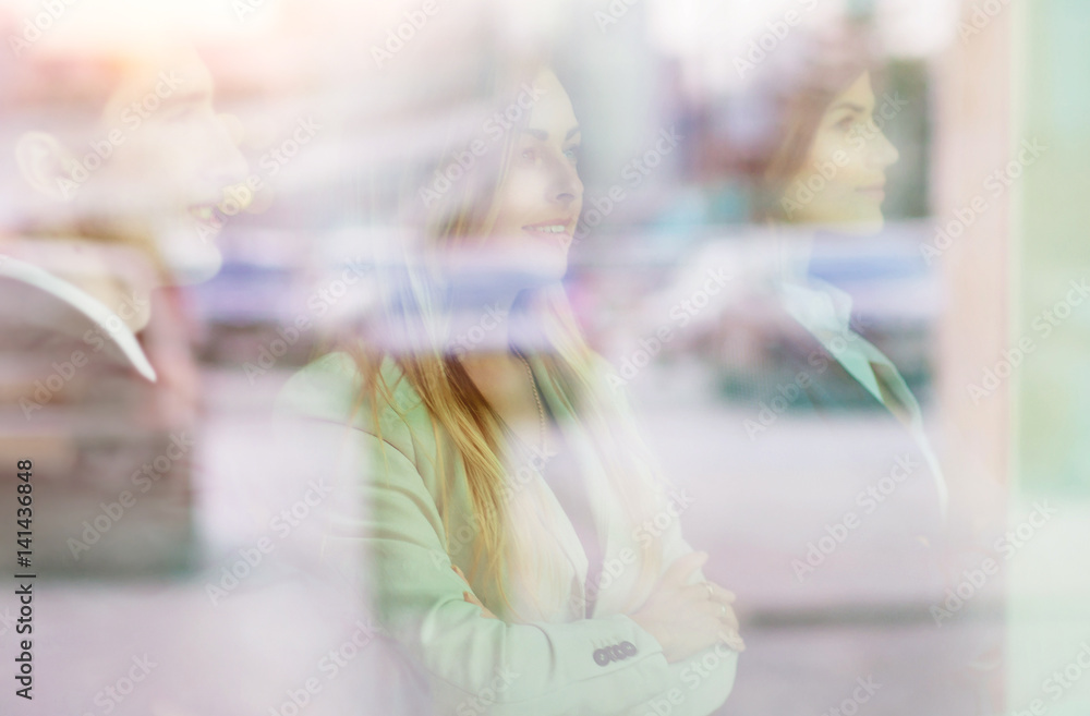 Group of successful businesspeople standing near the window Group of successful businesspeople standing near the window
