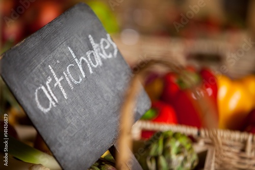Close-up of placard with artichokes word in organic section