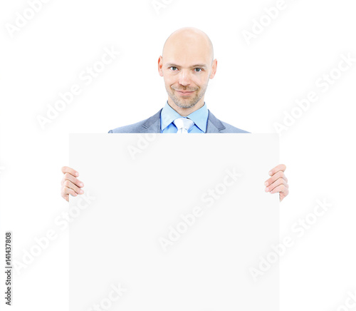 Nice businessman holds white poster. Isolated on white background.