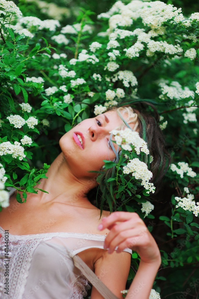 beautiful girl among green shrubs and white flowers breathe fragrance of nature beautiful girl among green shrubs and white flowers breathe fragrance of nature
