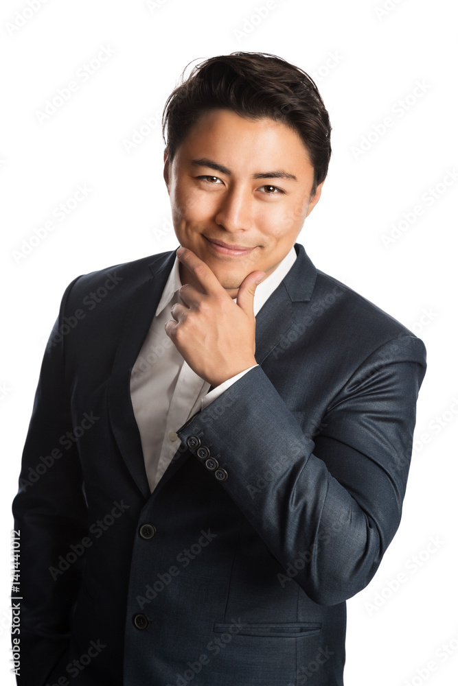 A well dressed businessman in a blue suit and white shirt, standing against a white background smiling towards camera. A well dressed businessman in a blue suit and white shirt, standing against a white background smiling towards camera.